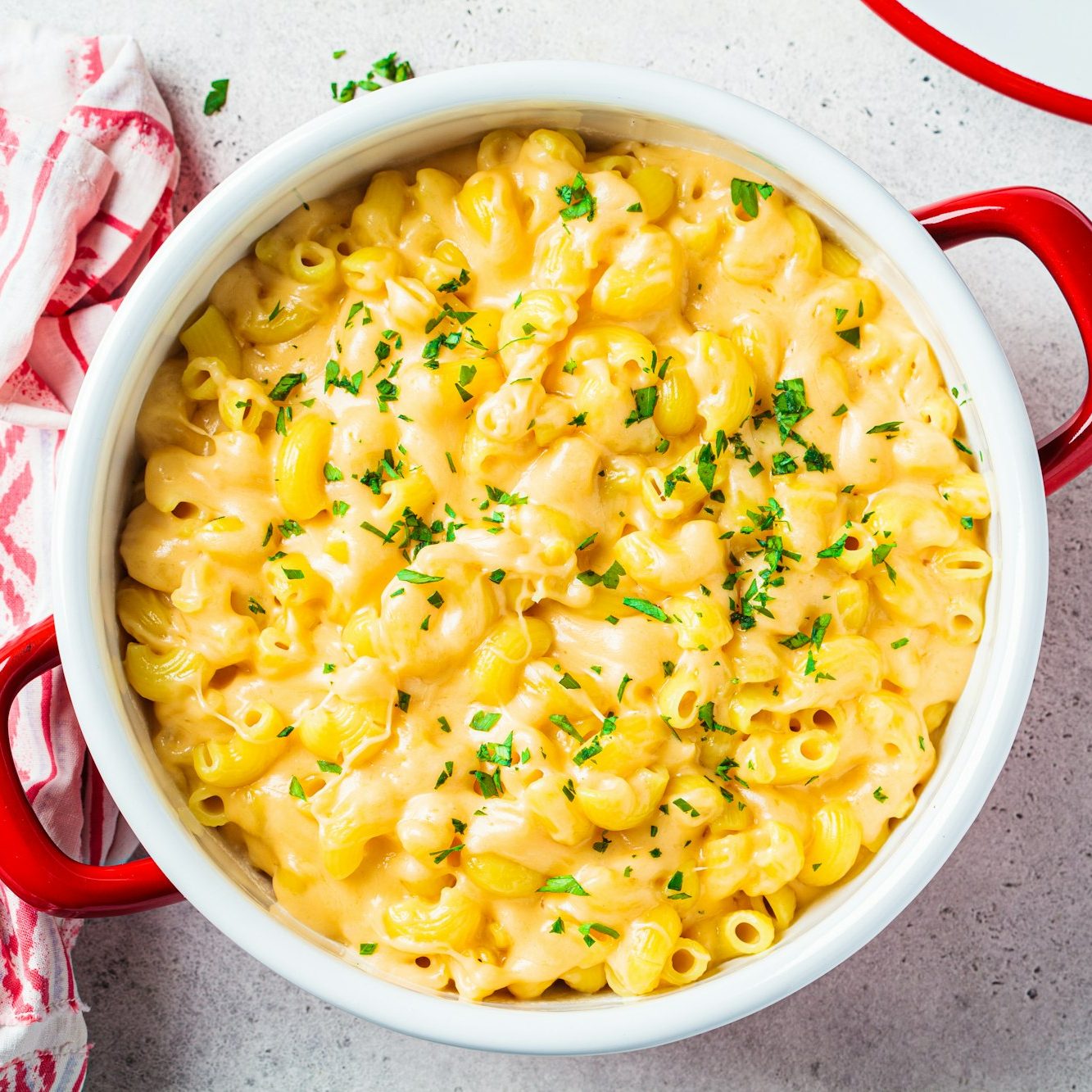 Mac and cheese in red pot. Traditional American food.